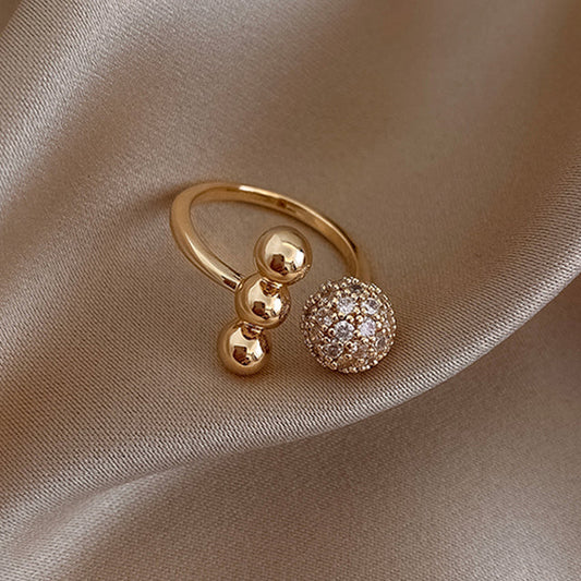 Eleganter Goldring mit Zirkoniumdioxid im dreifachen Kugeldesign